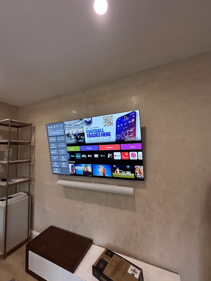 Wall-mounted television and soundbar installed in a living room